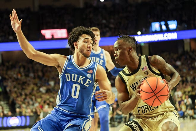 Feb 24, 2024; Winston-Salem, North Carolina, USA; Wake Forest Demon Deacons guard Kevin Miller (0) fights for position against Duke Blue Devils guard Jared McCain (0) during the first half at Lawrence Joel Veterans Memorial Coliseum. Mandatory Credit: Cory Knowlton-USA TODAY Sports