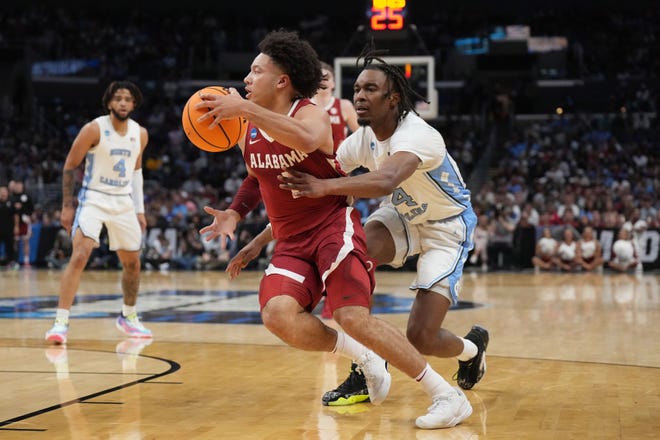 Mar 28, 2024; Los Angeles, CA, USA; Alabama Crimson Tide guard Mark Sears (1) controls the ball against North Carolina Tar Heels forward Jae'Lyn Withers (24) in the first half in the semifinals of the West Regional of the 2024 NCAA Tournament at Crypto.com Arena. Mandatory Credit: Kirby Lee-USA TODAY Sports