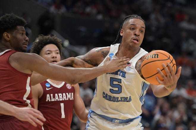 Mar 28, 2024; Los Angeles, CA, USA; North Carolina Tar Heels forward Armando Bacot (5) controls the ball against Alabama Crimson Tide forward Mohamed Wague (11) in the first half in the semifinals of the West Regional of the 2024 NCAA Tournament at Crypto.com Arena. Mandatory Credit: Jayne Kamin-Oncea-USA TODAY Sports
