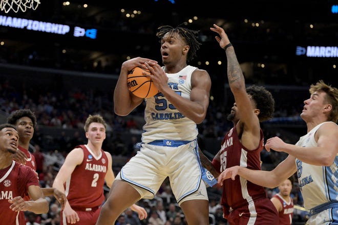 Mar 28, 2024; Los Angeles, CA, USA; North Carolina Tar Heels forward Harrison Ingram (55) controls a rebound against Alabama Crimson Tide guard Aaron Estrada (55) in the first half in the semifinals of the West Regional of the 2024 NCAA Tournament at Crypto.com Arena. Mandatory Credit: Jayne Kamin-Oncea-USA TODAY Sports