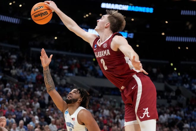 Mar 28, 2024; Los Angeles, CA, USA; Alabama Crimson Tide forward Grant Nelson (2) blocks North Carolina Tar Heels guard RJ Davis (4) in the second half in the semifinals of the West Regional of the 2024 NCAA Tournament at Crypto.com Arena. Mandatory Credit: Kirby Lee-USA TODAY Sports