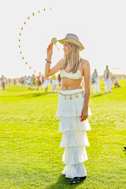 This festgoer finished off her ruffled maxi-skirt with a big charm belt.