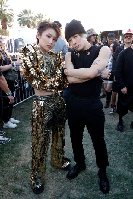 Liu Yuxin and Jackson Wang, seen backstage, dress up basic black with gold garland trim.