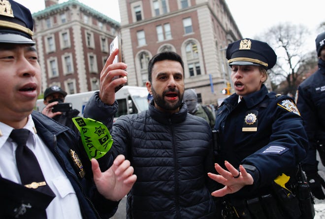 NYPD officers remove a man as pro-Palestinian protesters march outside Columbia University in New York City on April 18, 2024. Officers cleared out a pro-Palestinian campus demonstration on April 18, a day after university officials testified about anti-Semitism before Congress. Leaders of Columbia University defended the prestigious New York school's efforts to combat anti-Semitism on campus at a fiery congressional hearing on April 17.