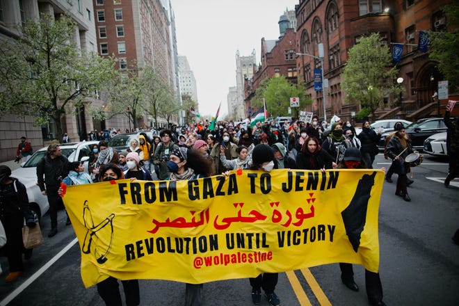 Pro-Palestinian protesters march outside Columbia University in New York City on April 18, 2024. Officers cleared out a pro-Palestinian campus demonstration on April 18, a day after university officials testified about anti-Semitism before Congress. Leaders of Columbia University defended the prestigious New York school's efforts to combat anti-Semitism on campus at a fiery congressional hearing on April 17.