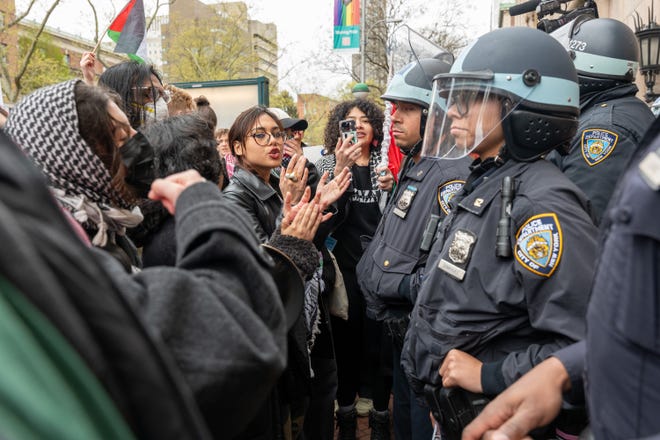 Students and pro-Palestinian activists face police as they gather outside of Columbia University to protest the university's stance on Israel on April 18, 2024, in New York City. The protests come after numerous students were arrested earlier in the day after setting up tents on the university lawn in support of Gaza.