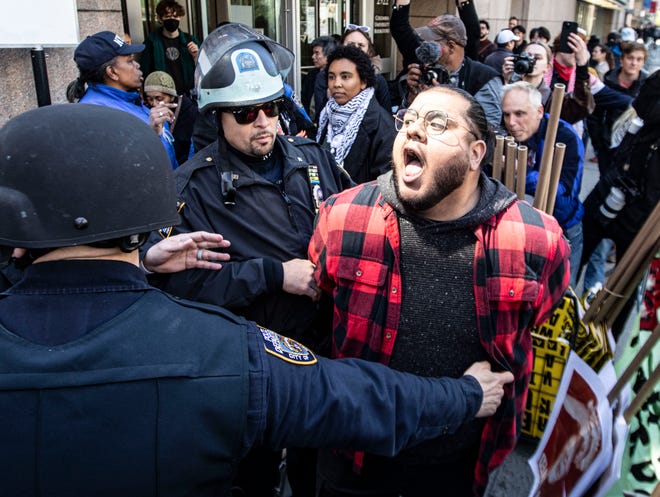 An anti-Israel protestor is arrested outside Columbia University in Manhattan April 22, 2024.