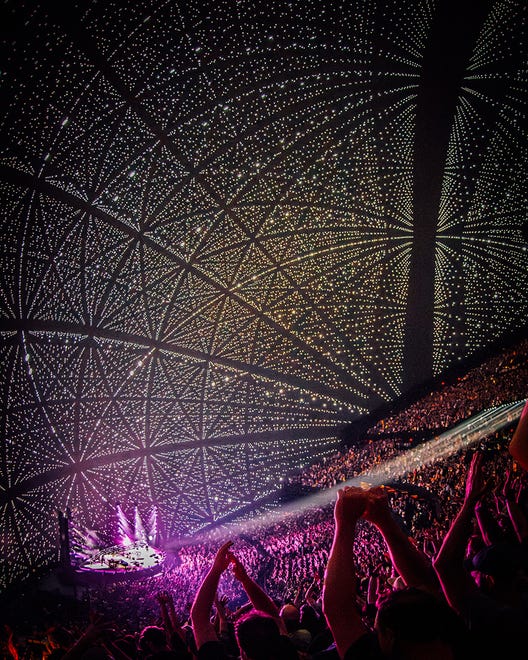 Video taken inside the concert captured towers of light, mesmerizing swirls of shapes and bursts of color during the concert. At one point, a giant puppy is displayed licking the screen as if the arena were its favorite ball.