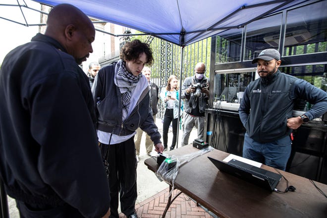 A Columbia University student gains access to the campus April 30, 2024. The university restricted access to students who live on campus and other essential personnel after student protesters took over Hamilton Hall on the campus early Tuesday morning.