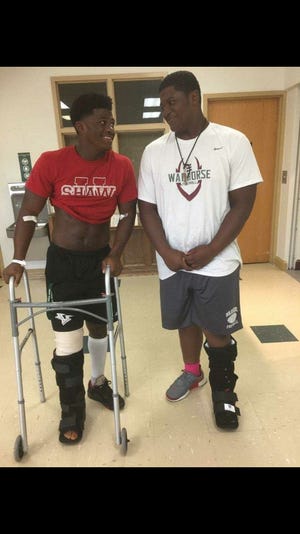 Sidney Gibbs (left) smiles with his younger brother Saevion Gibbs at the hospital after Sidney  sustained a tibial shaft fracture.