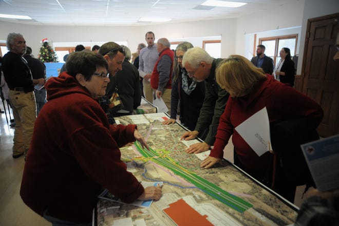 Area residents look over a potential design for an I-40 interchange at Blue Ridge Road on Dec. 13 in the Lakeview Center.