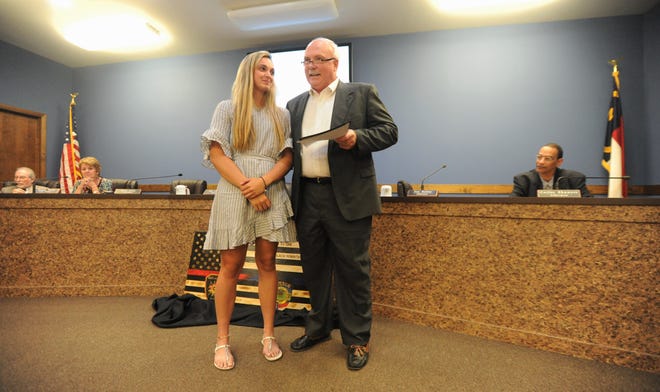 Black Mountain alderman Tim Raines introduces his former player Chesney Gardner before reading a proclamation recognizing the NCHSAA Female Athlete of the Year for 2019.