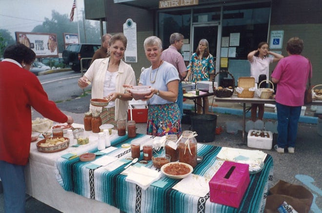 Mary Soyenova, left, and Renate Rikker serve salsa at the Valley Garden Market, which they founded in 1994. Now known as the Black Mountain Tailgate Market, the organization will celebrate 25 years on July 20.