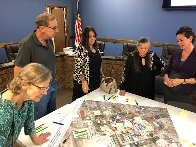 Rachel Bronson, right, of Traffic Planning and Development, Inc. reviews parking data with members of the public and town staff during an Aug. 27 meeting.