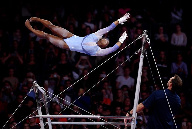 Oct. 5: Simone Biles performs on the uneven Bars during the qualifying session of the FIG Artistic Gymnastics World Championships at Stuttgart, Germany.
