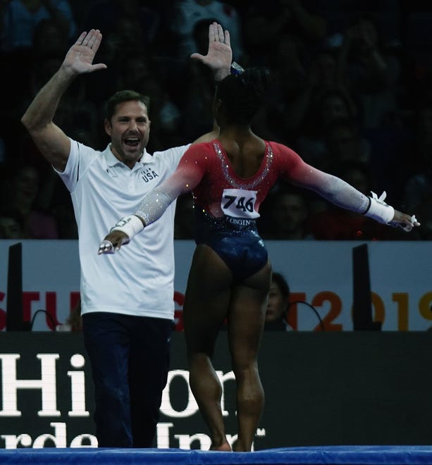 Oct. 8: Simone Biles celebrates with her coach after performing on the uneven bars. USA won the gold medal ahead of Russia (silver) and Italy (bronze).