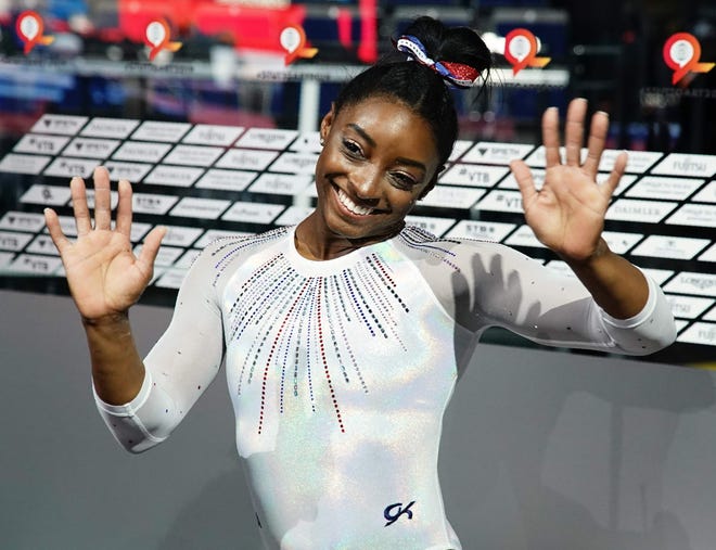 Simone Biles celebrates winning the gold medal in the women's all-around final.