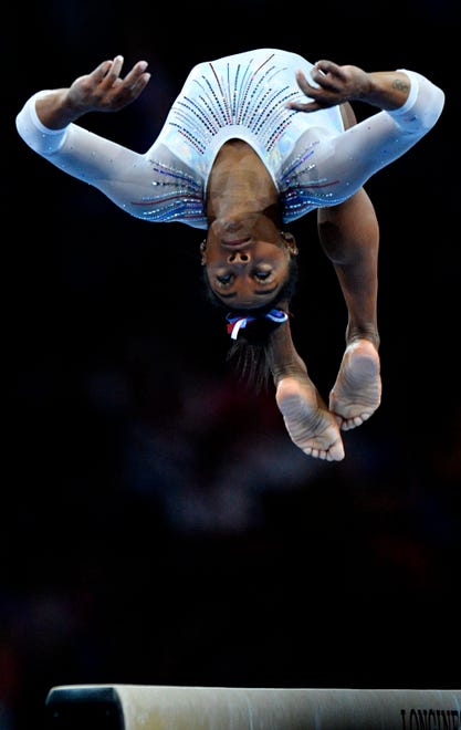Simone Biles performs on the beam during the women's all-around final.