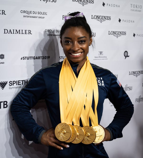 Simone Biles of USA poses with her five gold medals in the mixed zone after the women's Apparatus Final.