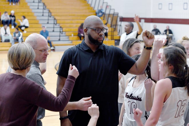 Owen girls basketball coach Anderson Bynum talks with his team during their game against North Buncombe at Owen High School on Jan. 2, 2020.