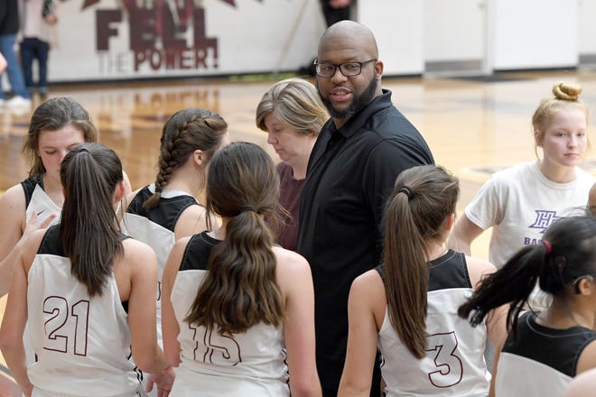 Owen girls basketball coach Anderson Bynum talks with his team during their game against North Buncombe at Owen High School on Jan. 2, 2020.