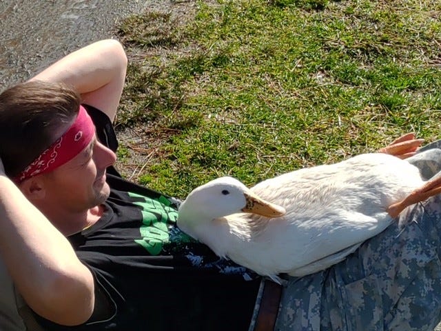 James Hewitt and a new lake resident relaxing on a 70-degree day at Lake Tomahawk.