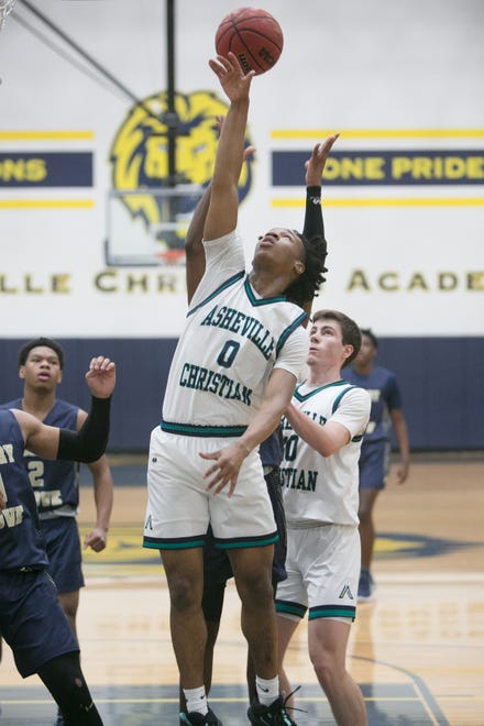 Asheville Christian Academy's Collin Mills tries for a rebound in the Lions' game against Hickory Grove Christian on Feb. 15, 2020 at ACA in Swannanoa. ACA won 71-69.