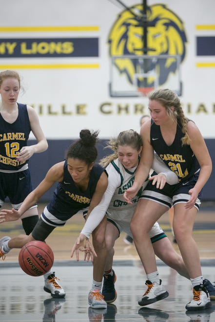 Asheville Christian Academy's Caroline Sikkink fights for the ball as ACA's girls face off against Carmel Christian on Feb. 15, 2020, at ACA in Swannanoa in the NCISAA playoff quarterfinals. The Lions took the win with a final score of 66-40 and move to the playoff semifinals on Feb. 21.