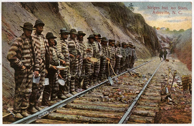 In 1875, in an effort to cut costs, the Western North Carolina Railroad began leasing convicts to help lay track from Old Fort to Asheville. Some of the convicts are seen in this historic postcard.