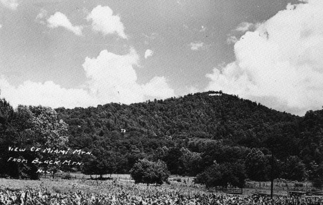 This photo shows a view of Miami Mountain from Black Mountain, circa late 1910s. During the first quarter of the 20th century, Miami Mountain was the home of the Sunset Park Hotel (also called the Peabody Hotel), one of Black Mountain’s busiest tourist attractions.