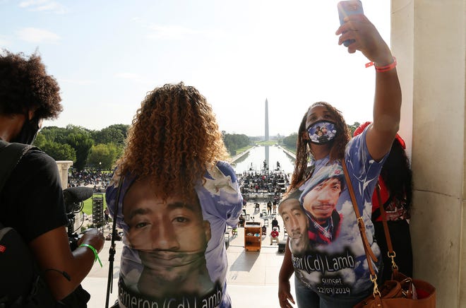 Laurie Bey, whose son Cameron Lamb was shot and killed by Kansas City police in 2019, stands with Merlon Ragland, Cameron's aunt, as demonstrators gather at the Lincoln Memorial as final preparations are made for the March on Washington.