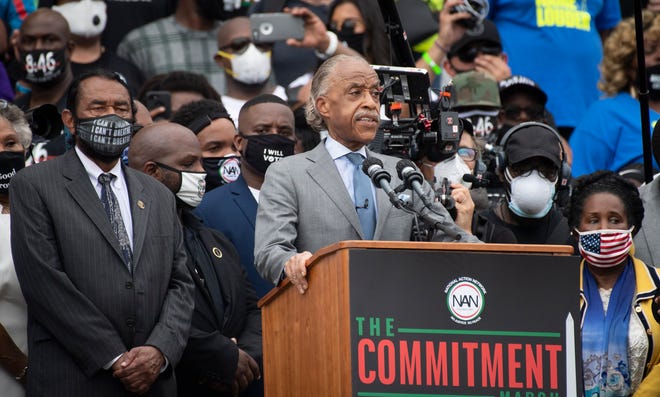 Congresswoman Sheila Jackson Lee, right, and Congressman Al Green stand alongside Rev. Al Sharpton as he delivers remarks as people gather at the 'Get Off Our Necks' Commitment March on Washington on August, 28, 2020.