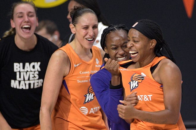 First round: Mercury guard Shey Peddy, right, is congratulated by teammates Shatori Walker-Kimbrough, second from right, Diana Taurasi and Alanna Smith, left, after Peddy hit a buzzer-beating three-pointer to lift Phoenix to a 85-84 win on Sept. 15, eliminating the Washington Mystics in the single-elimination game.