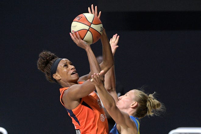 First round: Connecticut Sun guard Jasmine Thomas, left, puts up a shot over Chicago Sky guard Courtney Vandersloot during their single-elimination playoff game on Sept. 15.