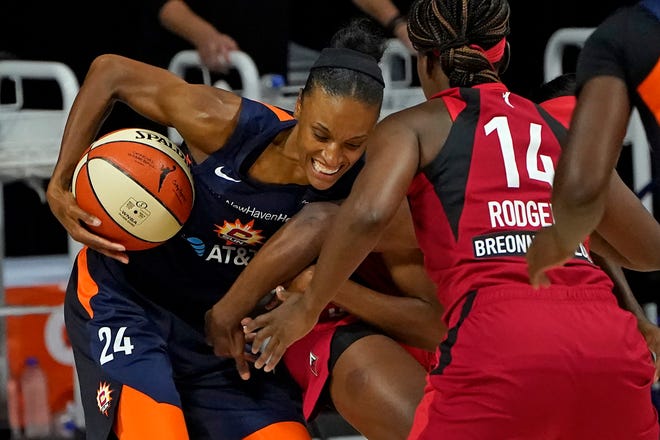 Semifinals: Connecticut Sun forward DeWanna Bonner, left, battles with Las Vegas Aces guard Sugar Rodgers (14) for a loose ball during Game 4 on Sept. 27. Bonner had 10 points and a season-high 15 rebounds.