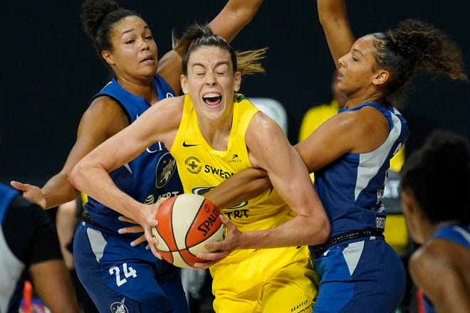 Semifinals: Seattle Storm forward Breanna Stewart, center, gets fouled by Minnesota Lynx forward Mikiah Herbert Harrigan, right, during Game 4. Stewart scored a career playoff-high 31 points – tying Seattle’s franchise playoff record.