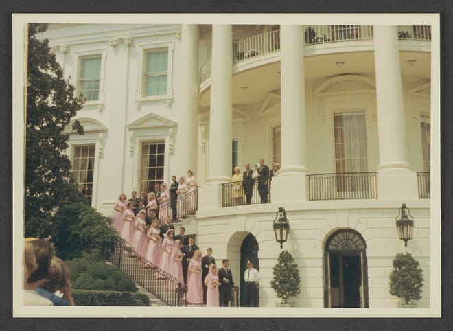 This photograph was taken on August 6, 1966 during the wedding reception for Luci Baines Johnson and Patrick Nugent. The couple was married at the National Shrine of the Immaculate Conception in Washington, D.C. and enjoyed their reception at the White House. The newly married couple stands on the South Portico, flanked by their parents, including President Lyndon B. Johnson and First Lady Lady Bird Johnson. Luci's bridesmaids are pictured descending the eastern stairs of the South Portico, wearing matching pink dresses and veils.

This photograph is part of a collection belonging to former White House Executive Chef Henry Haller. Haller served as executive chef of the White House from 1966-1987. Chef Haller oversaw the food preparations for Luci Baines Johnson's wedding reception.